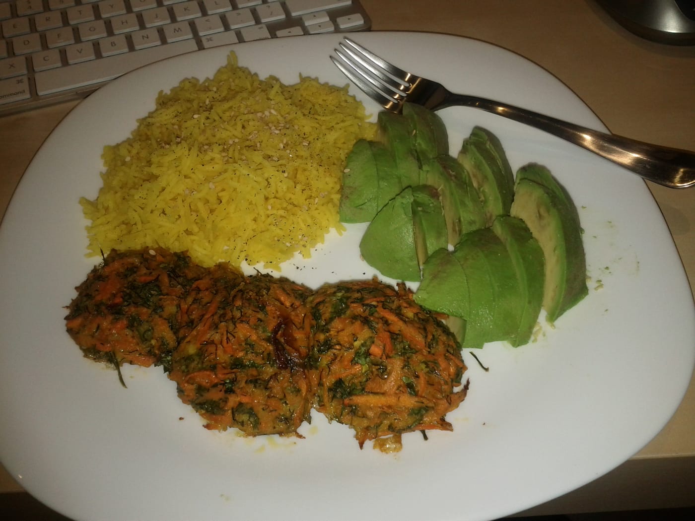 Baked carrot latkes with yellow rice and avocado