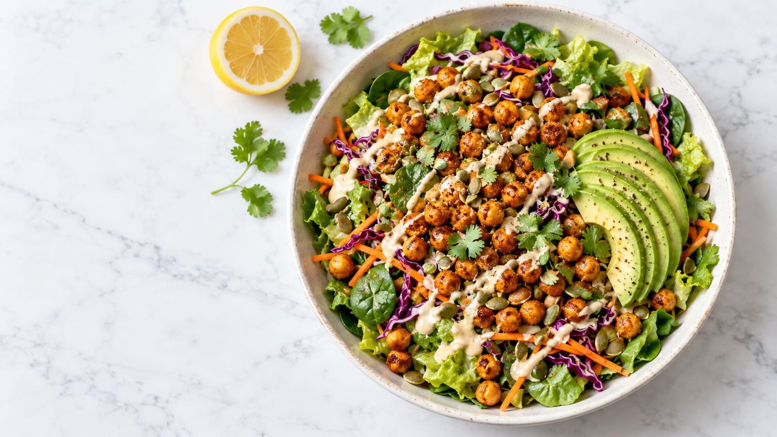 Roasted chickpeas and fanned avocado over romaine, spinach, shredded cabbage and carrot, finished with pumpkin seeds and tahini dressing.