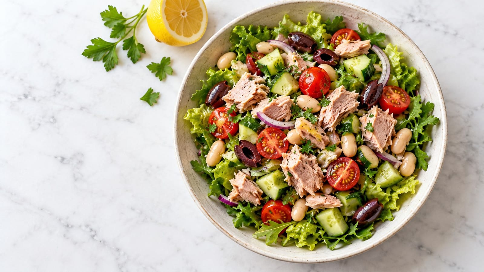 Flaked tuna and white beans on romaine and arugula with tomatoes, cucumber, red onion, Kalamata olives and parsley.
